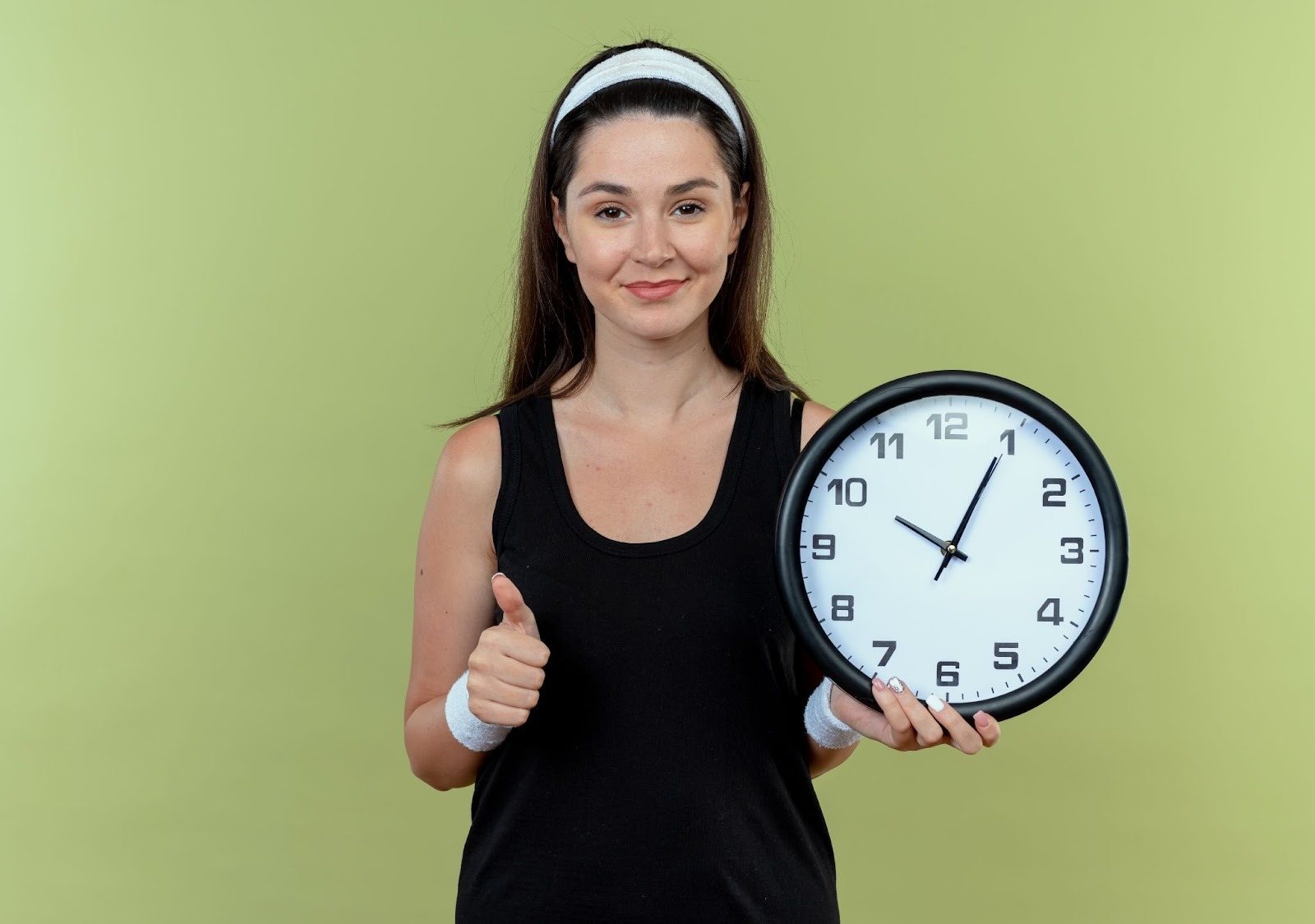 A woman holding a wall clock